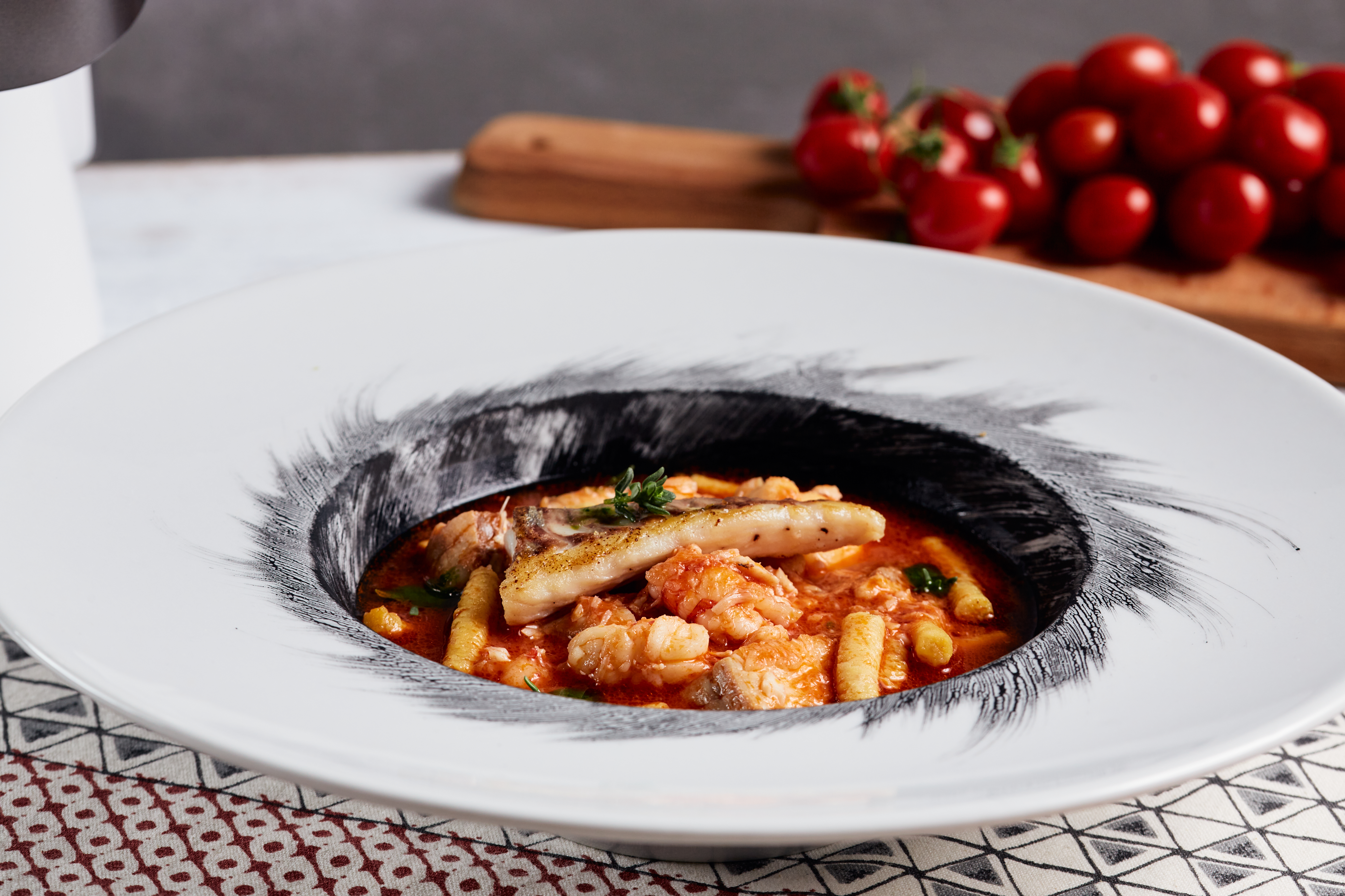 Passatelli in zuppa di mare al nero di seppia